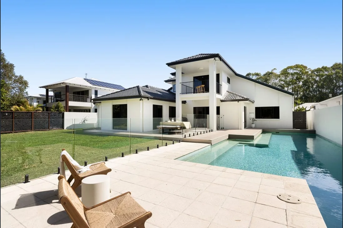 Frameless glass pool fence around a modern Townsville home